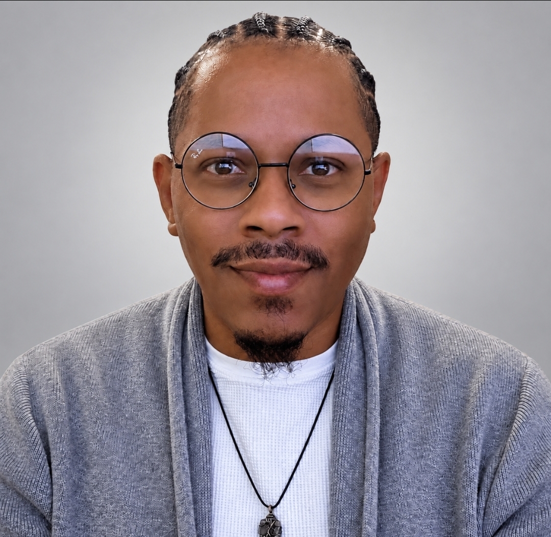 Jeremy Fusilier Sr. wearing glasses and a gray cardigan
